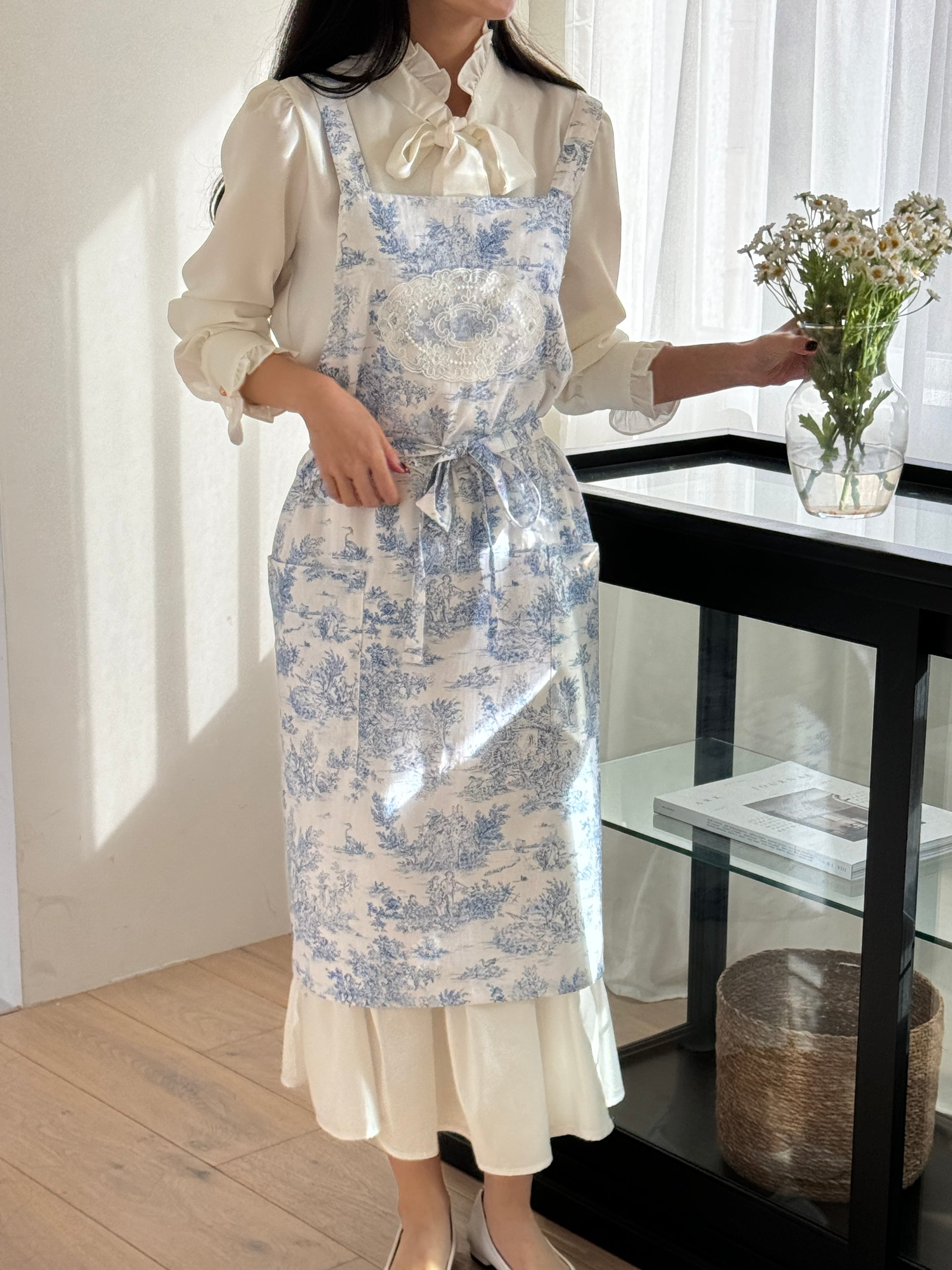 Velouving Toile De Jouy Apron displayed in black, perfect for stylish home chefs.