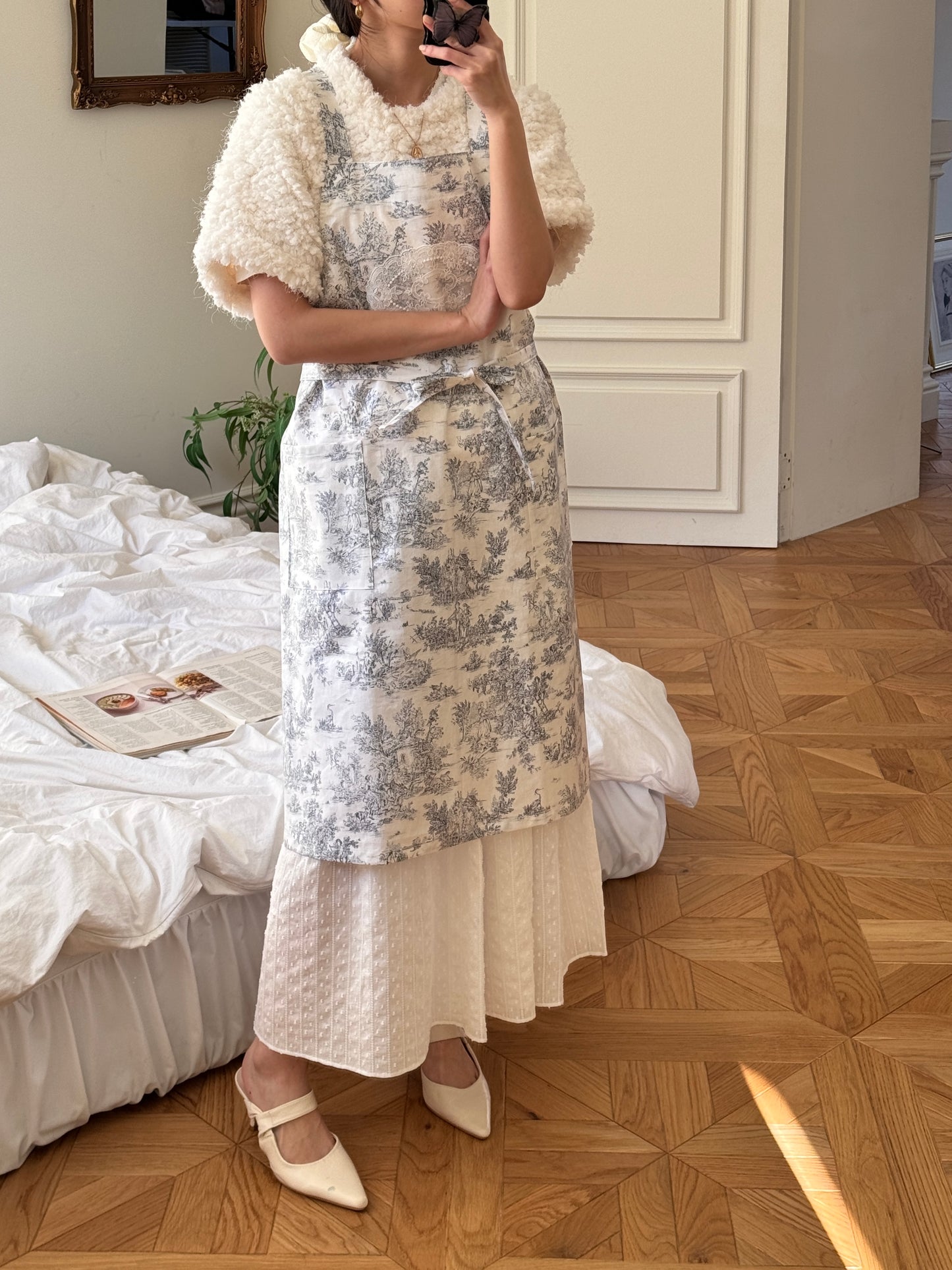 Velouving Toile De Jouy apron adding style and functionality to your routine.